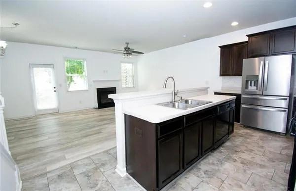 a kitchen with a sink cabinets stainless steel appliances and a window
