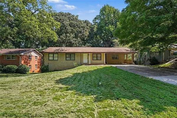 a front view of house with yard and green space