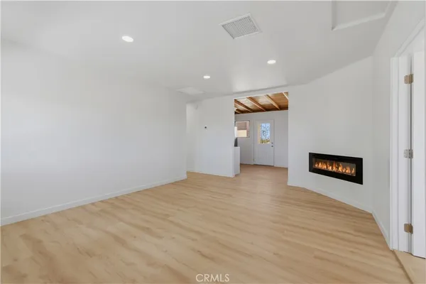 a view of empty room with a fireplace