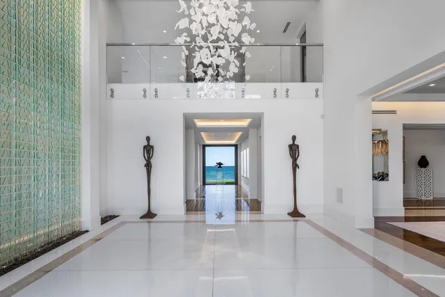 a large white kitchen with stainless steel appliances granite countertop a lot of counter space and wooden floor