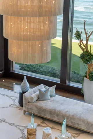 a living room with furniture and large windows