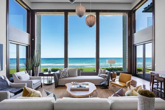 a living room with furniture a flat screen tv and a large window