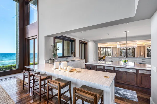 a living room with furniture large windows and a flat screen tv
