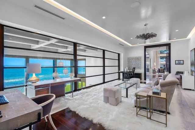 a front view of a house with a garden and trees