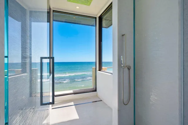 a dining room with stainless steel appliances kitchen island granite countertop a table chairs and a refrigerator