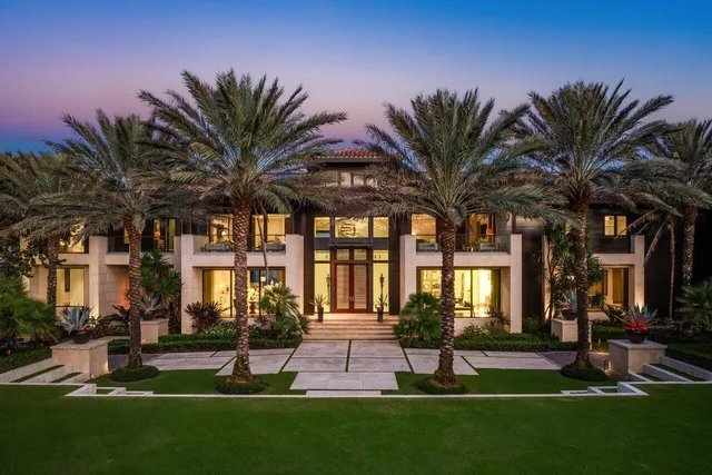 a living room with patio furniture and floor to ceiling window