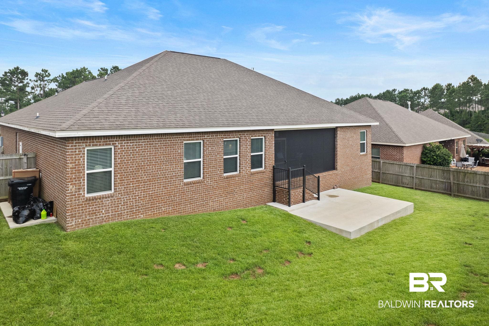 31541 Hoot Owl Road Daphne, AL 36527 - Photo 40 of 51 Back of house featuring a patio and a yard