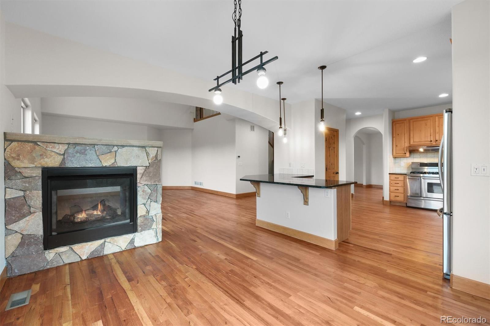 3191 Bittersweet Lane Evergreen, CO 80439 - Photo 14 of 50 a view of a kitchen with a fireplace and wooden floor