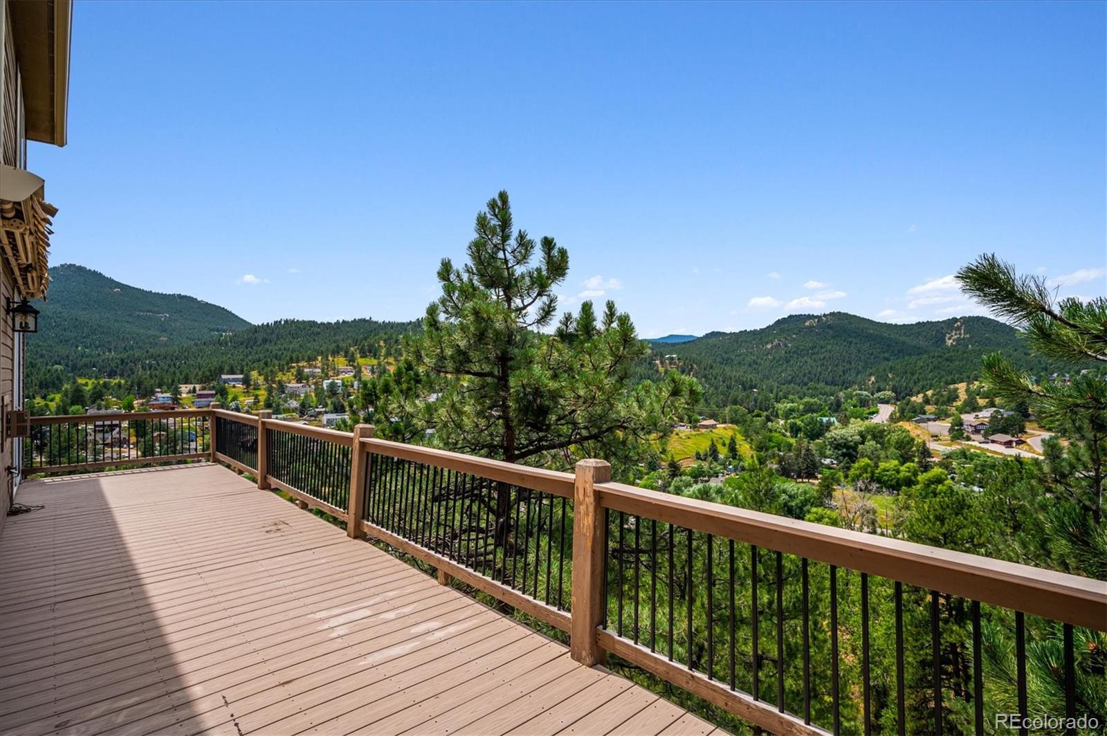 3191 Bittersweet Lane Evergreen, CO 80439 - Photo 16 of 50 a view of a balcony with wooden floor and fence