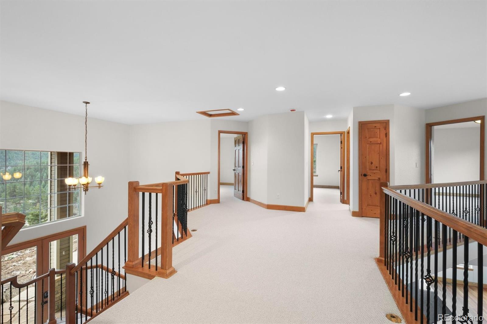 3191 Bittersweet Lane Evergreen, CO 80439 - Photo 17 of 50 a view of a hallway with windows