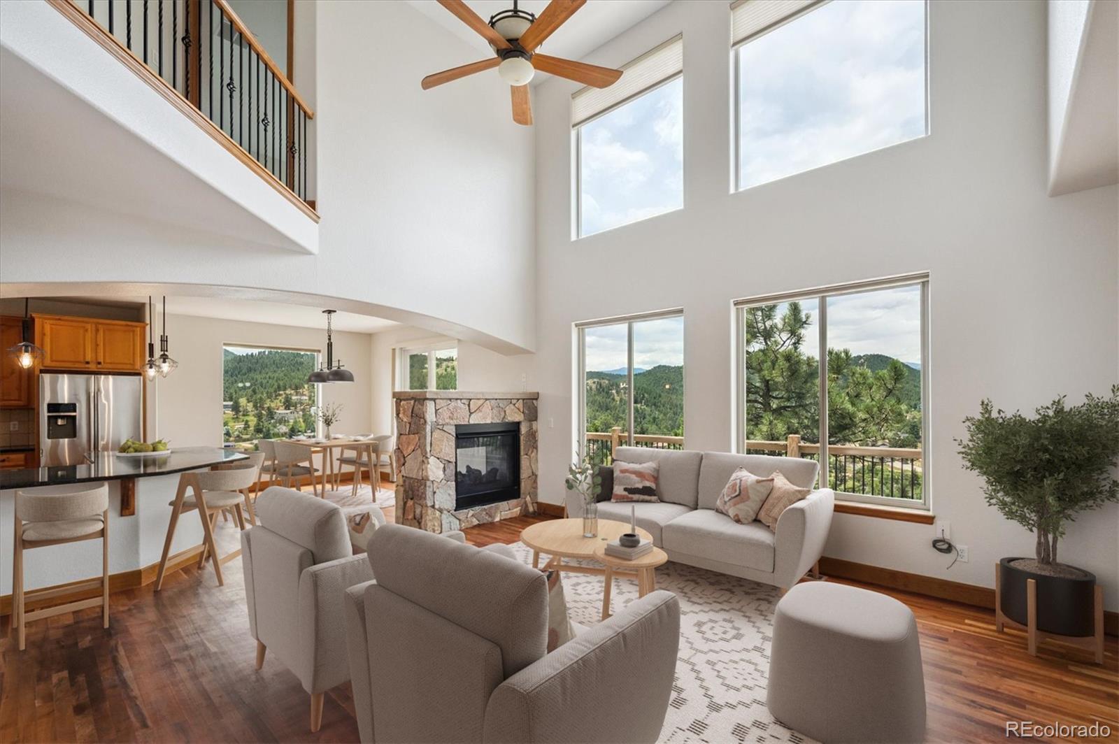 3191 Bittersweet Lane Evergreen, CO 80439 - Photo 2 of 40 a living room with furniture fireplace and a large window