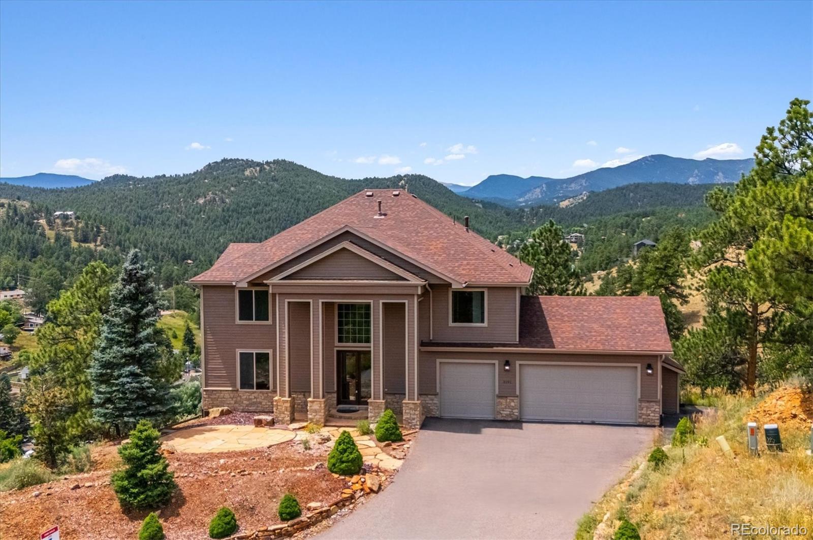 3191 Bittersweet Lane Evergreen, CO 80439 - Photo 2 of 50 a front view of a house with a yard and balcony