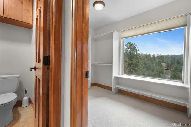 a bathroom with a toilet and a shower