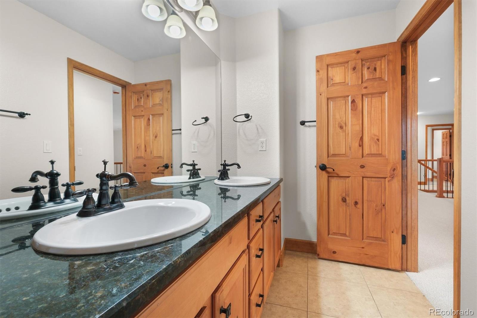 3191 Bittersweet Lane Evergreen, CO 80439 - Photo 22 of 40 a bathroom with a sink double vanity and a mirror
