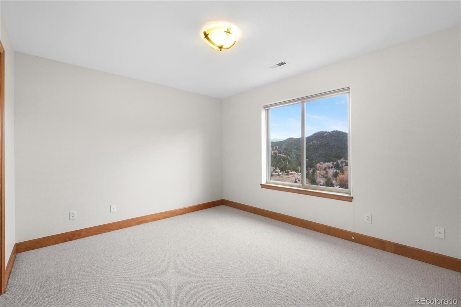 3191 Bittersweet Lane Evergreen, CO 80439 - Photo 25 of 50 a view of an empty room with a window