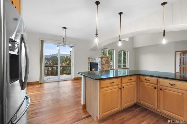 a kitchen with granite countertop a sink a counter space appliances and cabinets