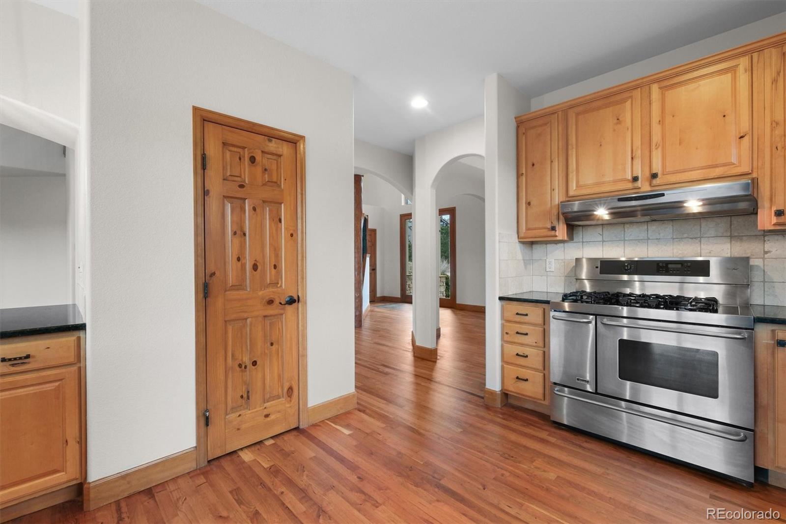 3191 Bittersweet Lane Evergreen, CO 80439 - Photo 9 of 40 a kitchen with stainless steel appliances a stove a sink and a window