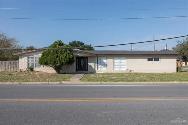 a front view of a house with a yard and a garage