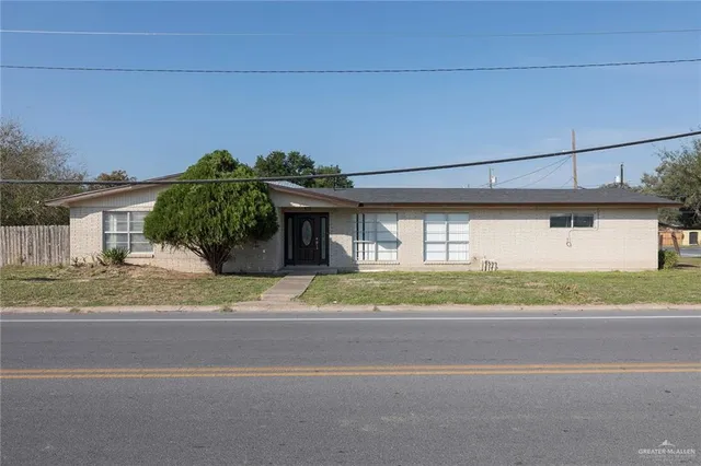 a front view of a house with a yard and a garage