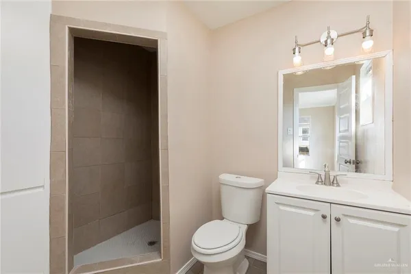 a bathroom with a toilet a sink and a mirror