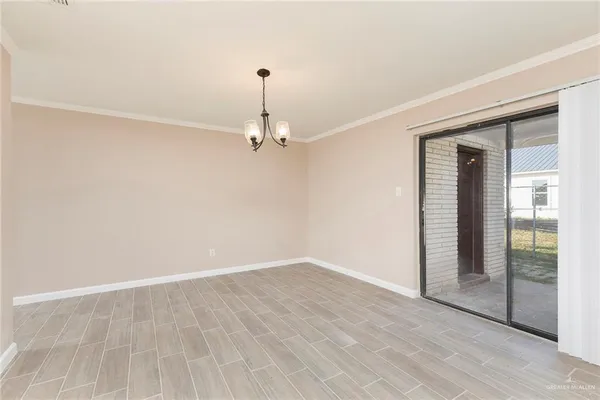 an empty room with wooden floor and door