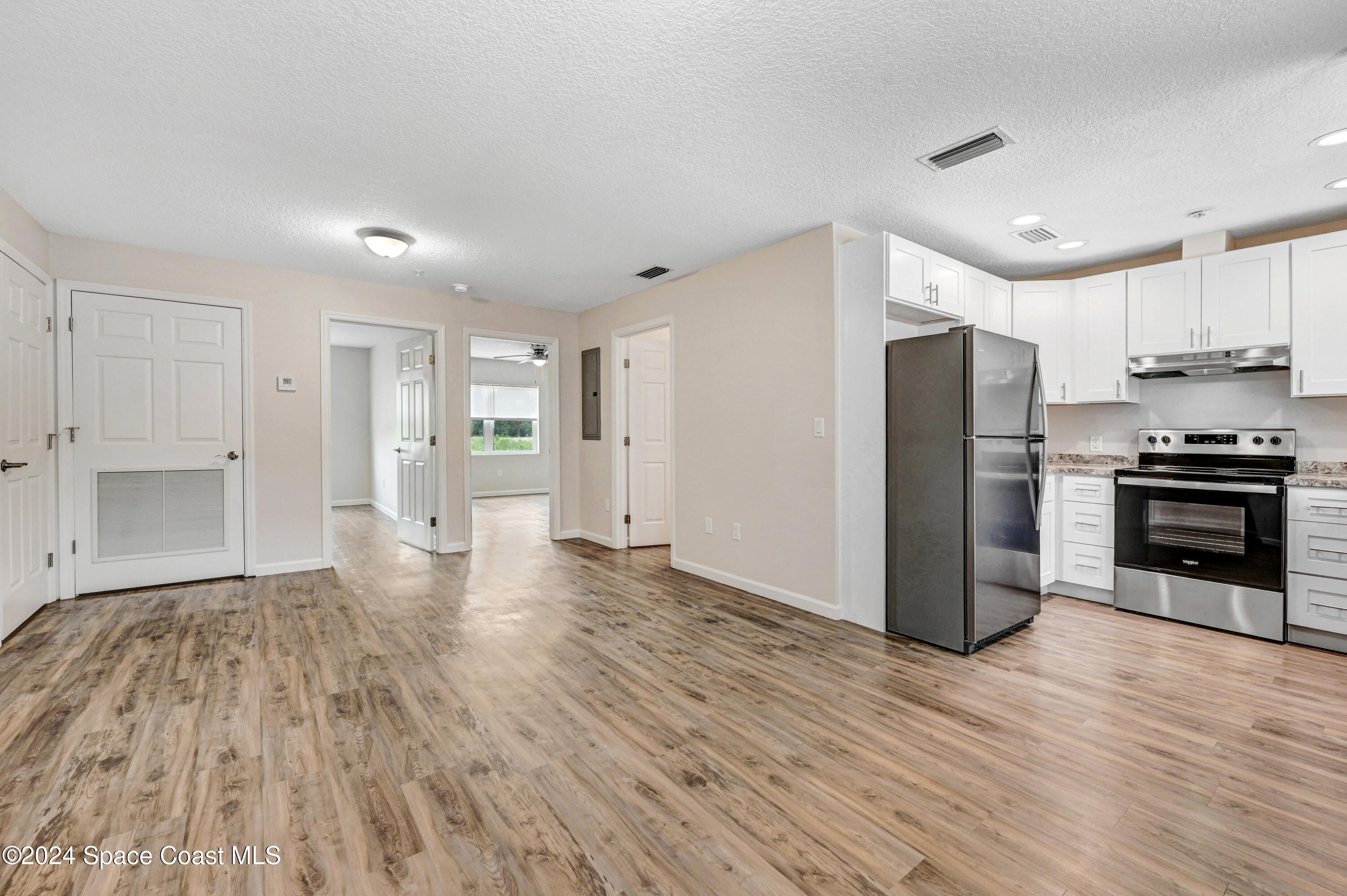 1895 Convair Street Southeast, Unit 2102 Palm Bay, FL 32909 - Photo 6 of 16 a kitchen with stainless steel appliances a refrigerator and a stove top oven