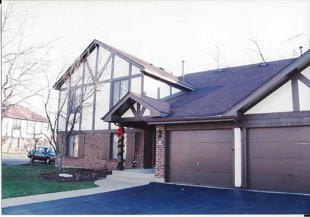 905 Knottingham Drive, Unit 2A Schaumburg, IL 60193 - Photo 1 of 13 a front view of a house with a yard