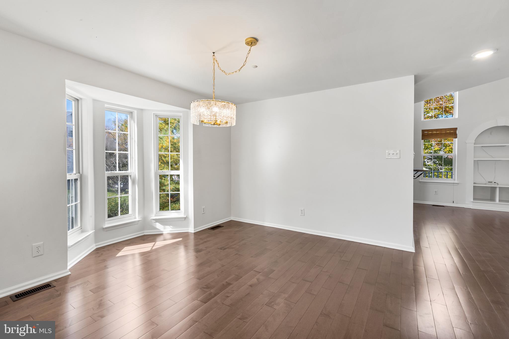 272 Militia Drive Wayne, PA 19087 - Photo 12 of 57 an empty room with wooden floor cabinet and windows