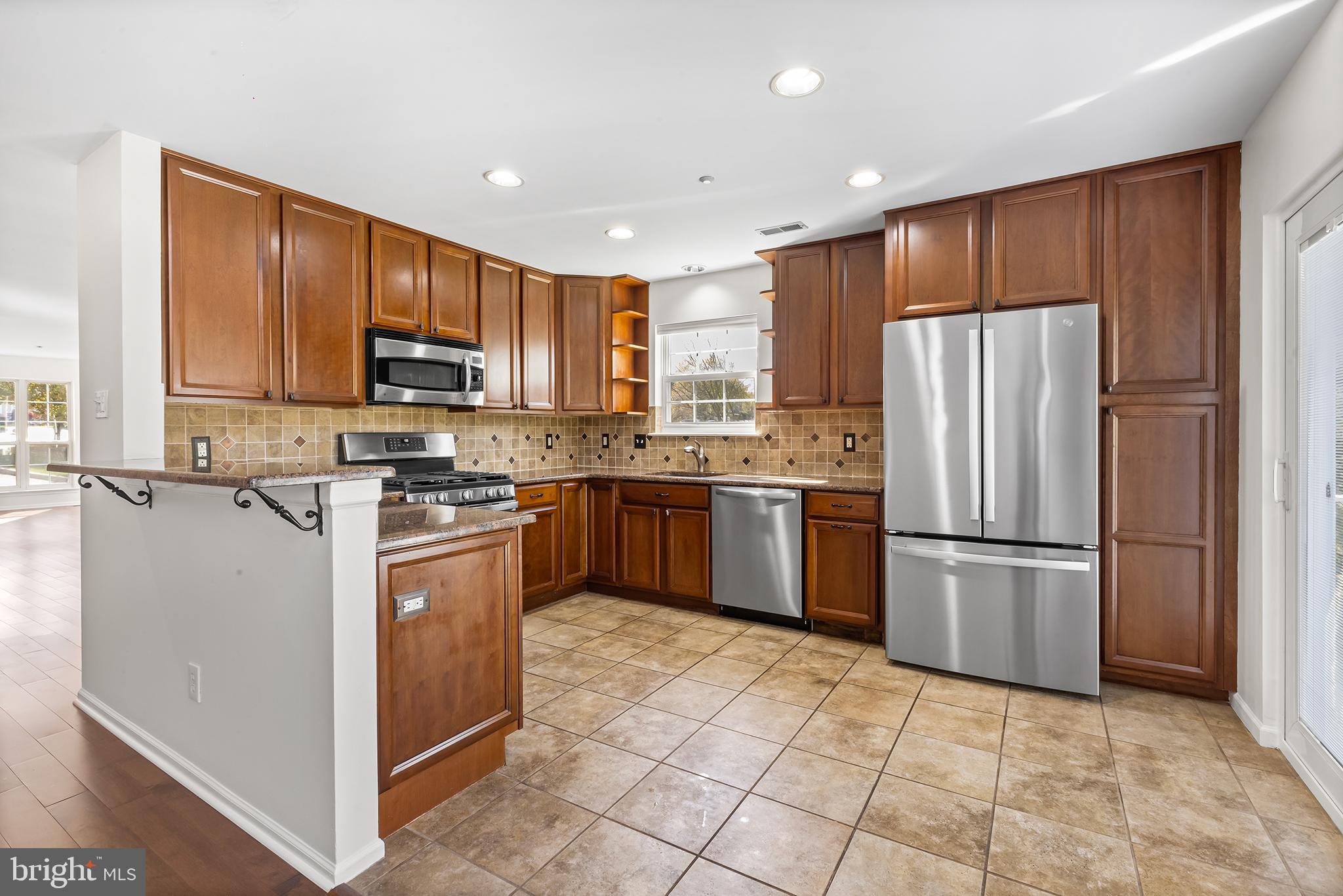 272 Militia Drive Wayne, PA 19087 - Photo 18 of 57 a kitchen with kitchen island a counter top space cabinets and stainless steel appliances
