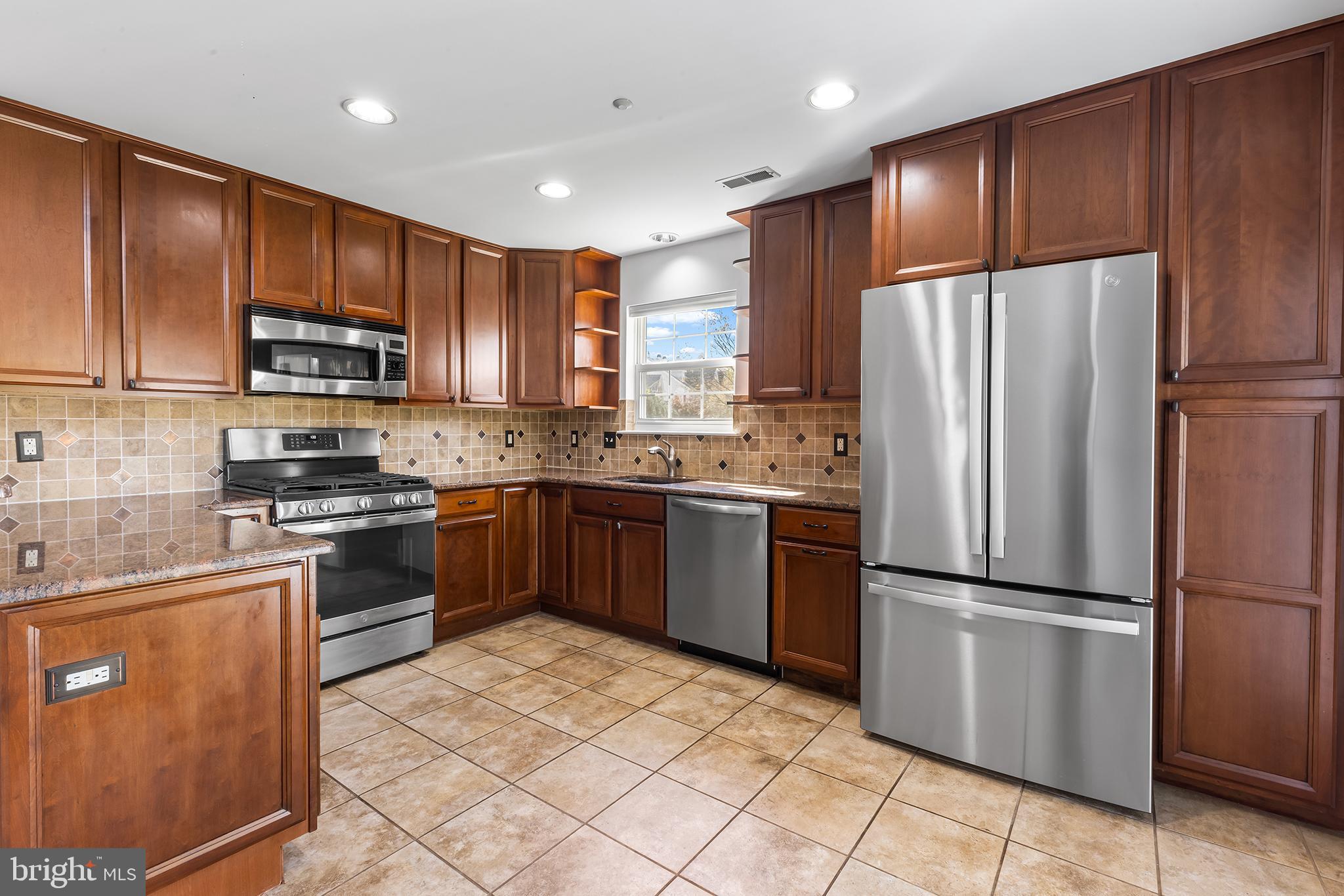 272 Militia Drive Wayne, PA 19087 - Photo 19 of 57 a kitchen with granite countertop stainless steel appliances and refrigerator