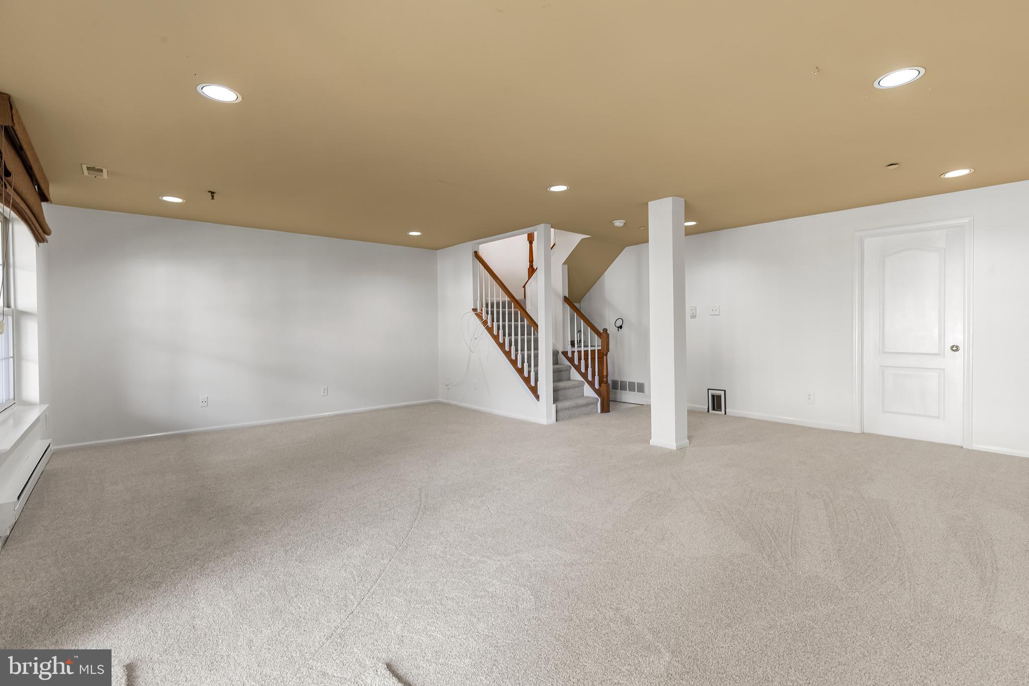 272 Militia Drive Wayne, PA 19087 - Photo 27 of 57 an empty room with a ceiling fan and stairs
