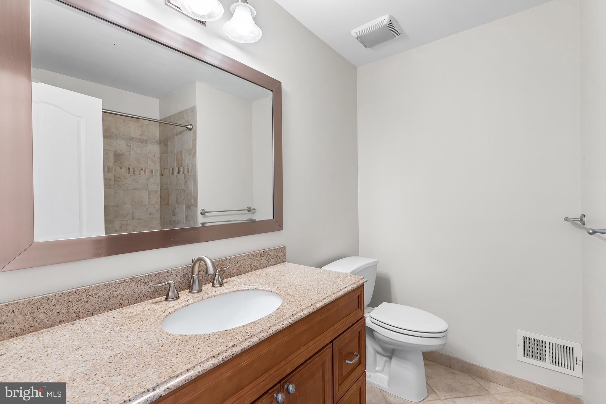 272 Militia Drive Wayne, PA 19087 - Photo 32 of 57 a bathroom with a granite countertop sink mirror vanity and toilet