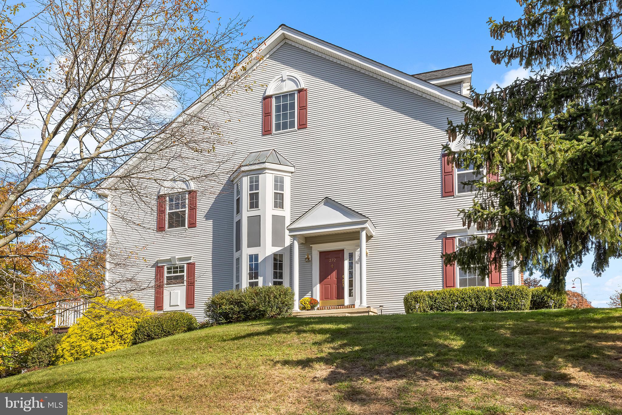 272 Militia Drive Wayne, PA 19087 - Photo 4 of 57 a view of a white house next to a yard with big trees