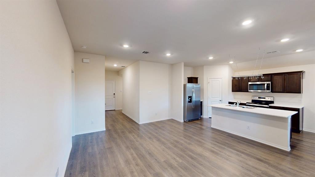 2210 Alamo Road Sherman, TX 75090 - Photo 5 of 17 Open-concept kitchen and living area featuring wood-finish flooring