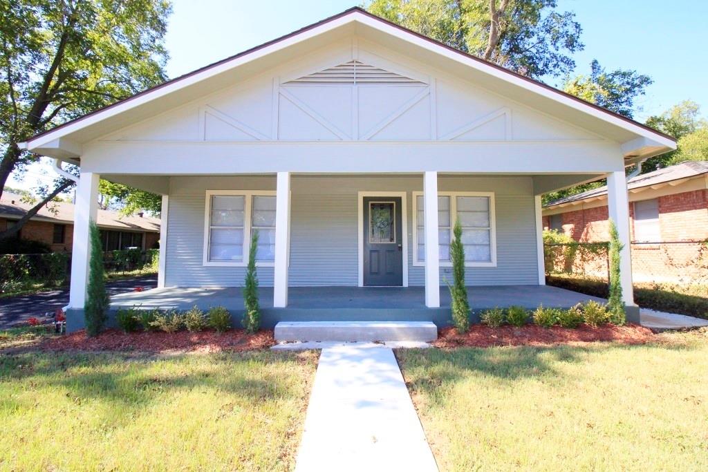 a front view of a house with swimming pool and glass windows