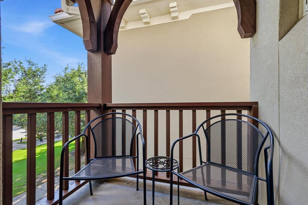 516 Sandy Lane Flower Mound, TX 75022 - Photo 24 of 38 Private balcony featuring a concrete floor, a wood railing, and decorative wood corbels supporting the roof overhang