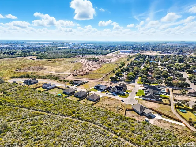 an aerial view of residential building and lake