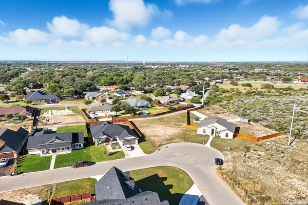 an aerial view of residential houses with outdoor space