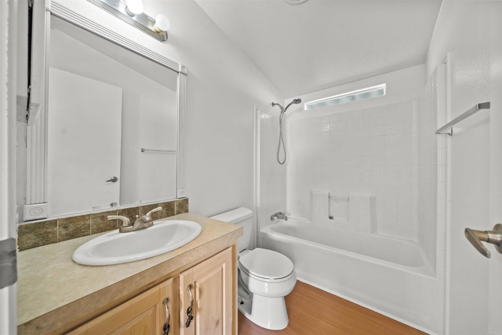 9902 Jamacha Boulevard, Unit 13 Spring Valley, CA 91977 - Photo 13 of 26 a bathroom with a sink toilet a mirror and shower