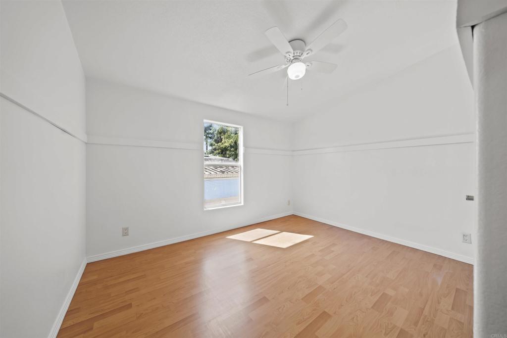 9902 Jamacha Boulevard, Unit 13 Spring Valley, CA 91977 - Photo 16 of 26 an empty room with windows and fan