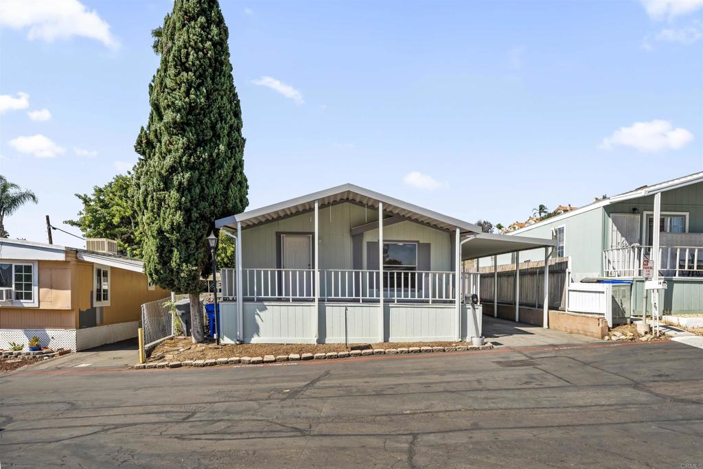 9902 Jamacha Boulevard, Unit 13 Spring Valley, CA 91977 - Photo 2 of 26 a front view of a house with a yard