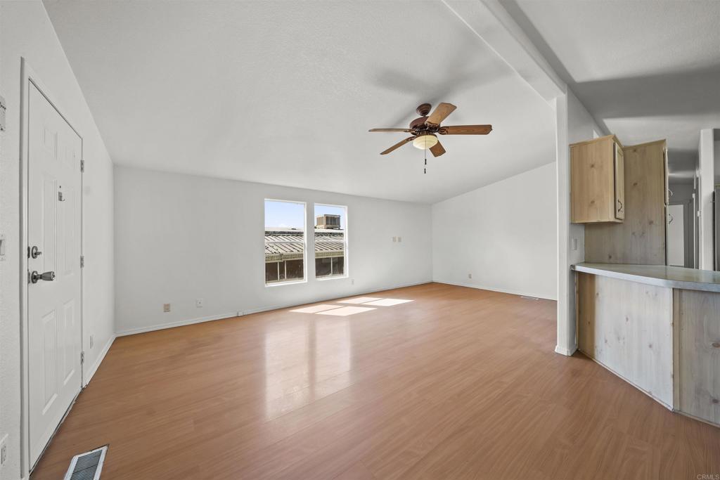 9902 Jamacha Boulevard, Unit 13 Spring Valley, CA 91977 - Photo 5 of 26 an empty room with windows and ceiling fan