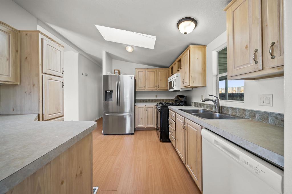9902 Jamacha Boulevard, Unit 13 Spring Valley, CA 91977 - Photo 9 of 26 a kitchen with stainless steel appliances granite countertop a sink refrigerator and cabinets