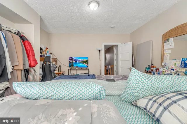 a bedroom with a bed and a couch