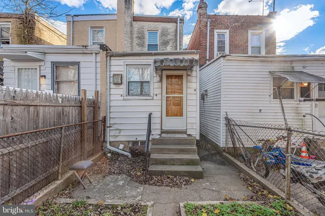 a view of a house with wooden fence