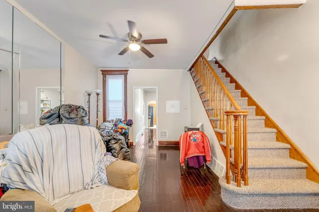 a living room with furniture or wooden floor and a chandelier