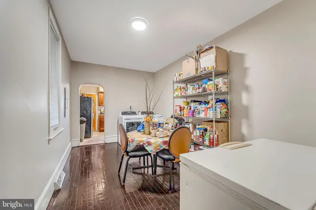a dining room with furniture and a window