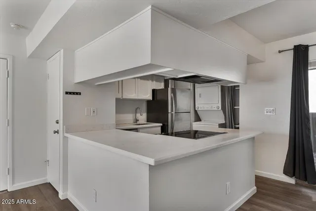 a view of a livingroom with wooden floor and a ceiling fan