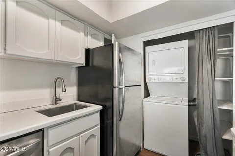 a kitchen with stainless steel appliances granite countertop a sink and a stove