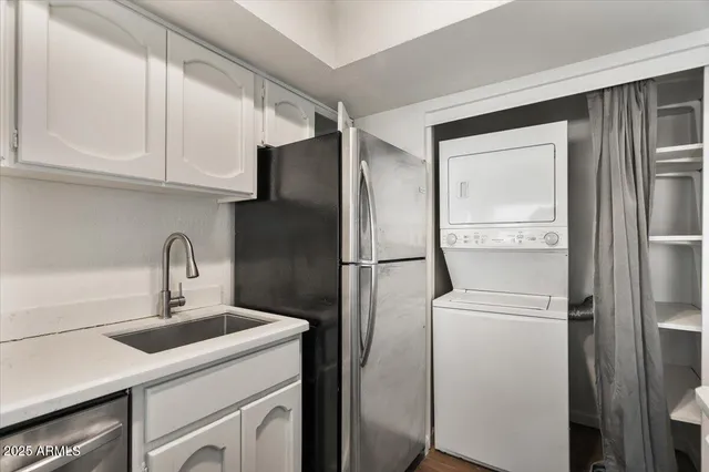 a kitchen with stainless steel appliances granite countertop a sink and a stove